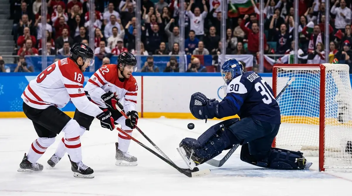Olympic ice hockey medal-round goaltender making kick save in tight game